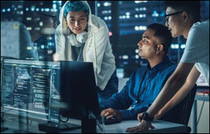 A diverse team of cybersecurity staff look at a computer screen; source Getty Images 1356364333